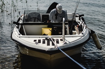 Buying a used fishing boat. Fisherman prepairing gear.k