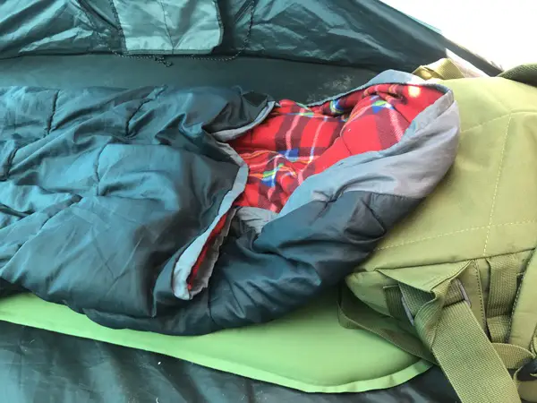 Improvised Pillows For Camping. Using backpack for pillow.