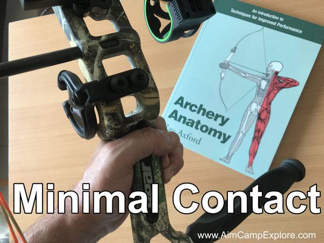 Holding compound bow with minimal hand contact